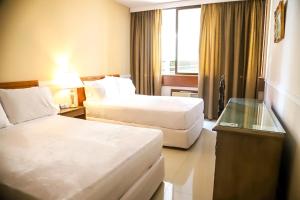 a hotel room with two beds and a window at Nobile Hotel Premier Hill in Asunción +47 photos