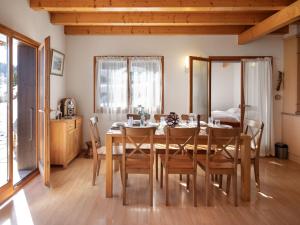 a dining room with a table and chairs at Chalet Orchidée by Interhome in Ovronnaz