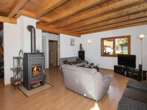 a living room with a couch and a fireplace at Chalet Orchidée by Interhome in Ovronnaz +25 photos