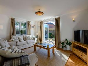 a living room with a couch and a tv at 3 Bed in Lymington oc-90002 in Sway