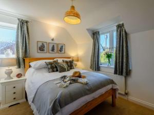 a bedroom with a bed with a teddy bear on it at 3 Bed in Lymington oc-90002 in Sway