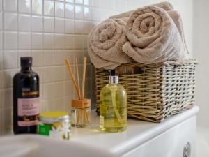 a basket of towels sitting on a counter next to a sink at 3 Bed in Lymington oc-90002 in Sway +20 photos