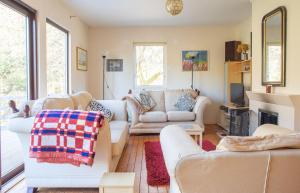 a living room with two couches and a fireplace at The Blue Lobster in Drynoch