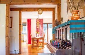 a living room with a fireplace and a table at The Blue Lobster in Drynoch