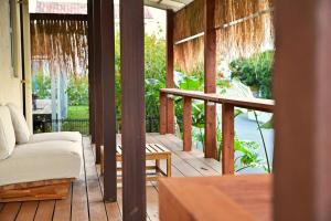 a screened in porch with a couch and a table at 南国リゾート Bari Okinawa 連泊宿泊限定価格 in Itoman