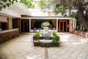 a fountain in the middle of a courtyard at Nobile Hotel Premier Hill in Asunción