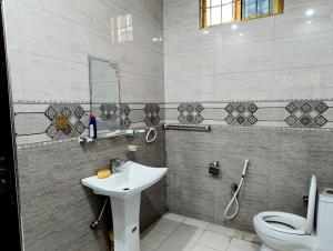 a bathroom with a sink and a toilet at House No 6, Valley Homes in Pothi