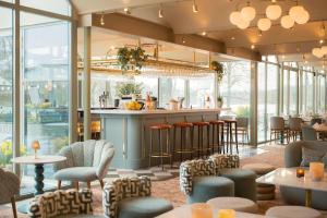 a restaurant with a bar and chairs and tables at Villa Källhagen in Stockholm