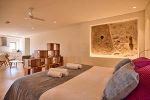 a bedroom with a large bed with two pillows at Finca Son Cladera in Sa Pobla +142 photos