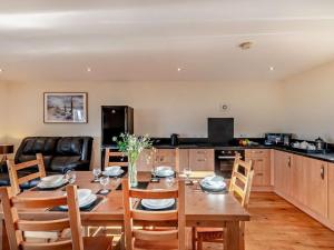 a kitchen and dining room with a wooden table and chairs at 3 Bed in Bishop Auckland oc-94320 in Wolsingham