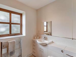 a white bathroom with a sink and a window at 3 Bed in Bishop Auckland oc-94320 in Wolsingham +20 photos