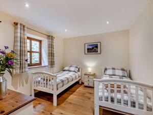 a nursery with two beds and a table at 3 Bed in Bishop Auckland oc-94320 in Wolsingham