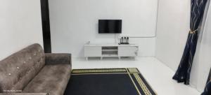 a living room with a couch and a tv at Homestay Rumah 311 in Sungai Petani