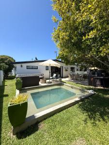 a swimming pool in the yard of a house at Lagoon Haven House in Hermanus
