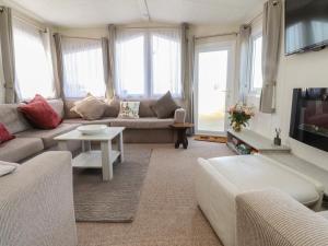 a living room with a couch and a table at Cornholme Lodge in Accrington