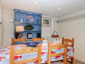 a dining room with a table and chairs at Yew Tree Cottage in Dartmouth