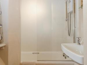 a bathroom with a shower and a sink at Yew Tree Cottage in Dartmouth +35 photos