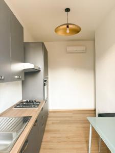 a kitchen with a sink and a stove top oven at Le Tre Lune Rooms in Matera