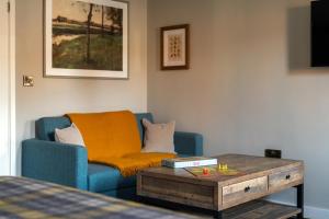 a living room with a couch and a coffee table at The White Hart in Stockbridge