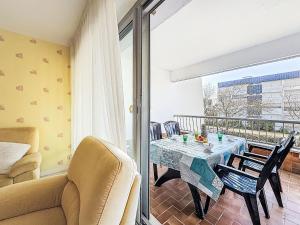 a living room with a table and chairs on a balcony at Apartment Kérabus-3 by Interhome in Quiberon +18 photos