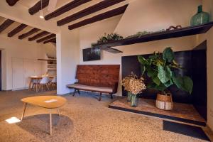 a living room with a bench and a fire place at Finca Son Cladera in Sa Pobla