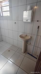 a bathroom with a toilet and a sink at Pousada Itararé in São Vicente +24 photos