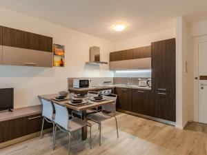 a kitchen and dining room with a table and chairs at Apartment Ilaria by Interhome in Riva del Garda