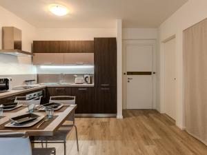 a kitchen with a table and chairs in a room at Apartment Ilaria by Interhome in Riva del Garda