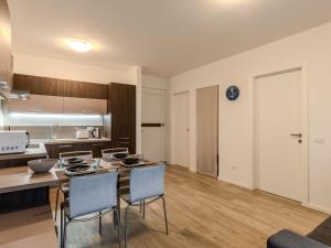 a kitchen and living room with a table and chairs at Apartment Ilaria by Interhome in Riva del Garda
