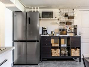 a kitchen with a stainless steel refrigerator at Apartment Vårhemsplatsen by Interhome in Halmstad