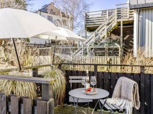a patio with a table and an umbrella at Apartment Vårhemsplatsen by Interhome in Halmstad