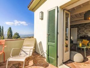 a patio with chairs and a door and a table at Holiday Home Nobile by Interhome in Polveraia +30 photos