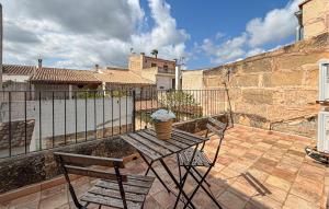 a wooden table and two chairs on a patio at Convent Holiday Home in Petra