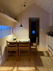 a dining room with a table and chairs at Mountain Cabin With Sauna At Blefjell in Lampeland +32 photos