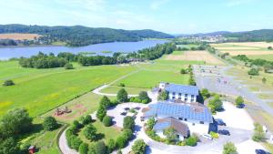 an aerial view of a building with a lake at Seehof Hotel am Aartalsee in Bischoffen