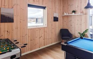 a room with a pool table and a chair at Awesome Home In Grenaa With Sauna in Grenå +21 photos