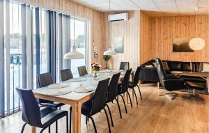 a dining room with a table and chairs at Awesome Home In Grenaa With Sauna in Grenå