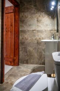 a bathroom with a shower and a sink and a toilet at Old Town Nest in Rhodes Town