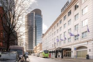 a green bus parked in front of a building at a&o Brussel Centrum in Brussels