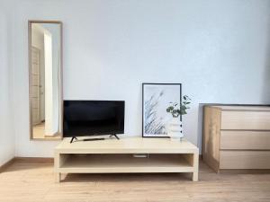 a living room with a tv on a table at Imantas apartment in Daugavpils