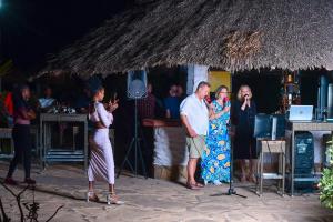 a group of people standing in front of a bar at The Garden Suite in Mtwapa +31 photos
