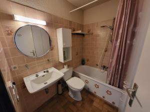 a bathroom with a sink and a toilet and a mirror at Studio Residentie Astrid Bredene in Bredene +19 photos