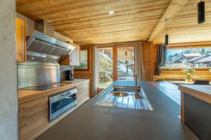 a kitchen with a sink and a counter top at Hameau des clos Virolet in Les Gets