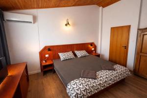 a small bedroom with a bed and a desk at Family House FreeДом in Sinemorets +41 photos
