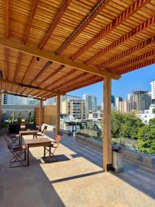 a wooden pergola with a table and chairs on a patio at Hotel Boutique Casa Mia in Santa Marta