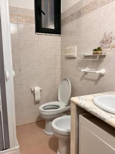 a bathroom with a toilet and a sink at Casa sul mare da Giovanna in La Caletta +12 photos