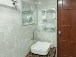 a bathroom with a sink and a toilet in it at Diamond Stay Inn in Dhangethi
