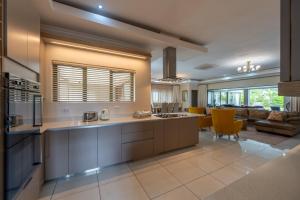 a kitchen with a large island in a room at The House in Hazyview
