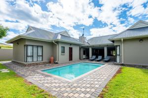 a house with a swimming pool in the yard at The House in Hazyview