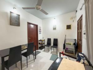 a dining room with black chairs and a table at Diamond Stay Inn in Dhangethi